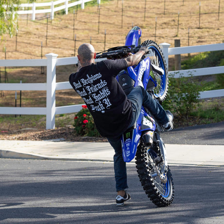 Black T-shirt on a rider with back text: Bad Decisions, Bad Friends, Bad Shits