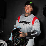 Kinetic DBK jersey with light gray body, red shoulder panel, and black logo sleeve