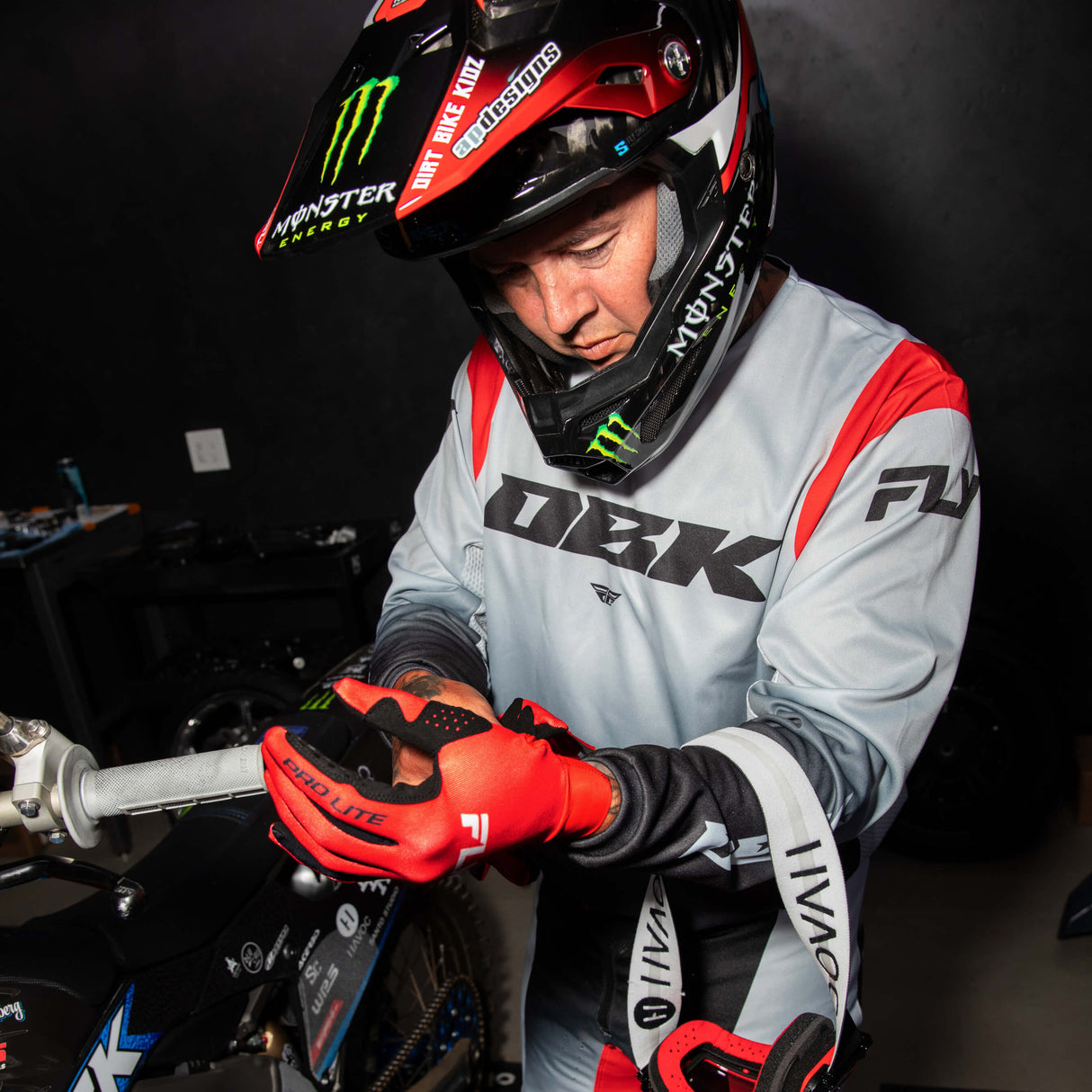 Motocross jersey in light gray and black with red sleeve accents and large DBK logo across chest