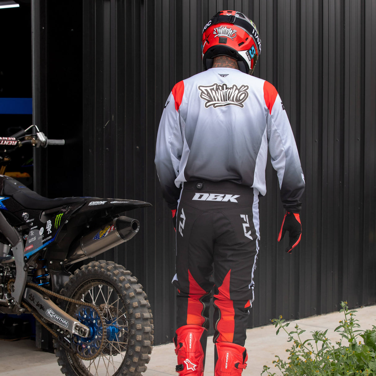Black and red motocross pants shown from behind with DRK branding on thigh