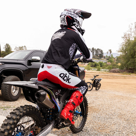 Motocross pant, black with white and red accents and protective knee and shin panels