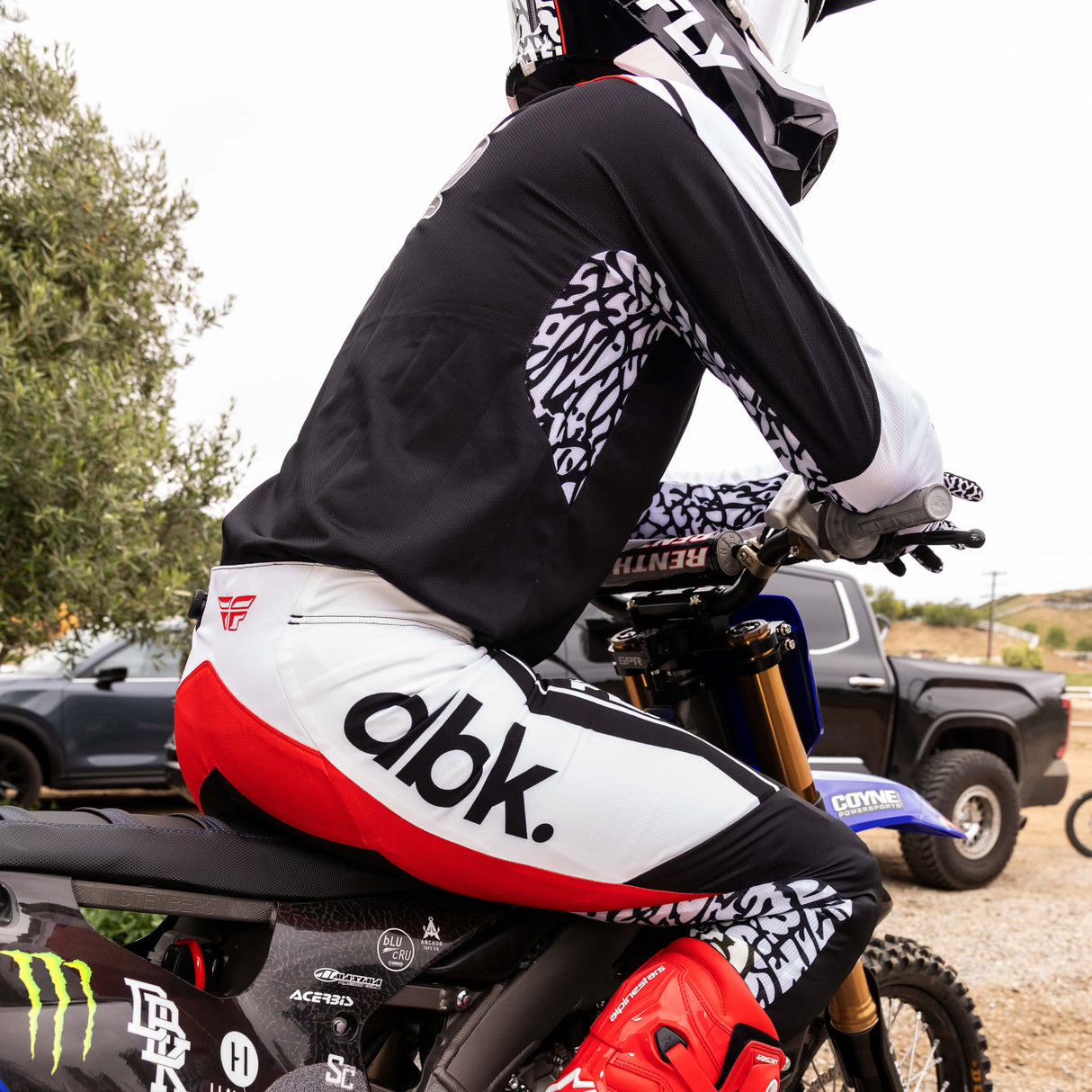 Motorcycle pant, black and white with bold red stripe and patterned side panels