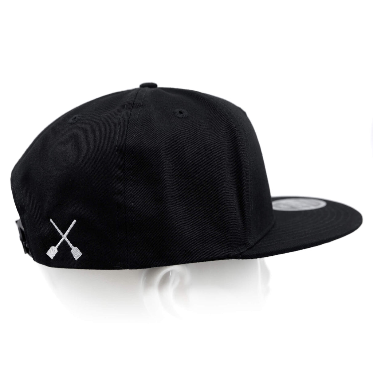 Black snapback hat with white X logo on the back panel.