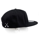 Black snapback hat with white X logo on the back panel.