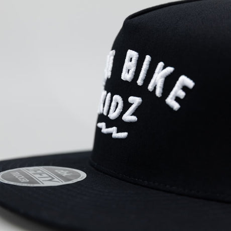 Close-up of black cap with “Dirt Bike Kidz” embroidery on the side