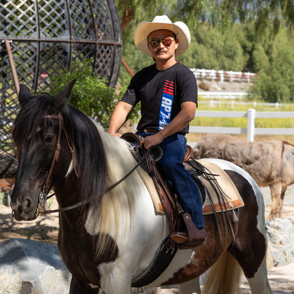 Black Roadhouse AP7 tee worn on horseback, with vertical APXDBK logo on chest
