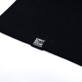 Black youth tank top hem with small brand label tag.