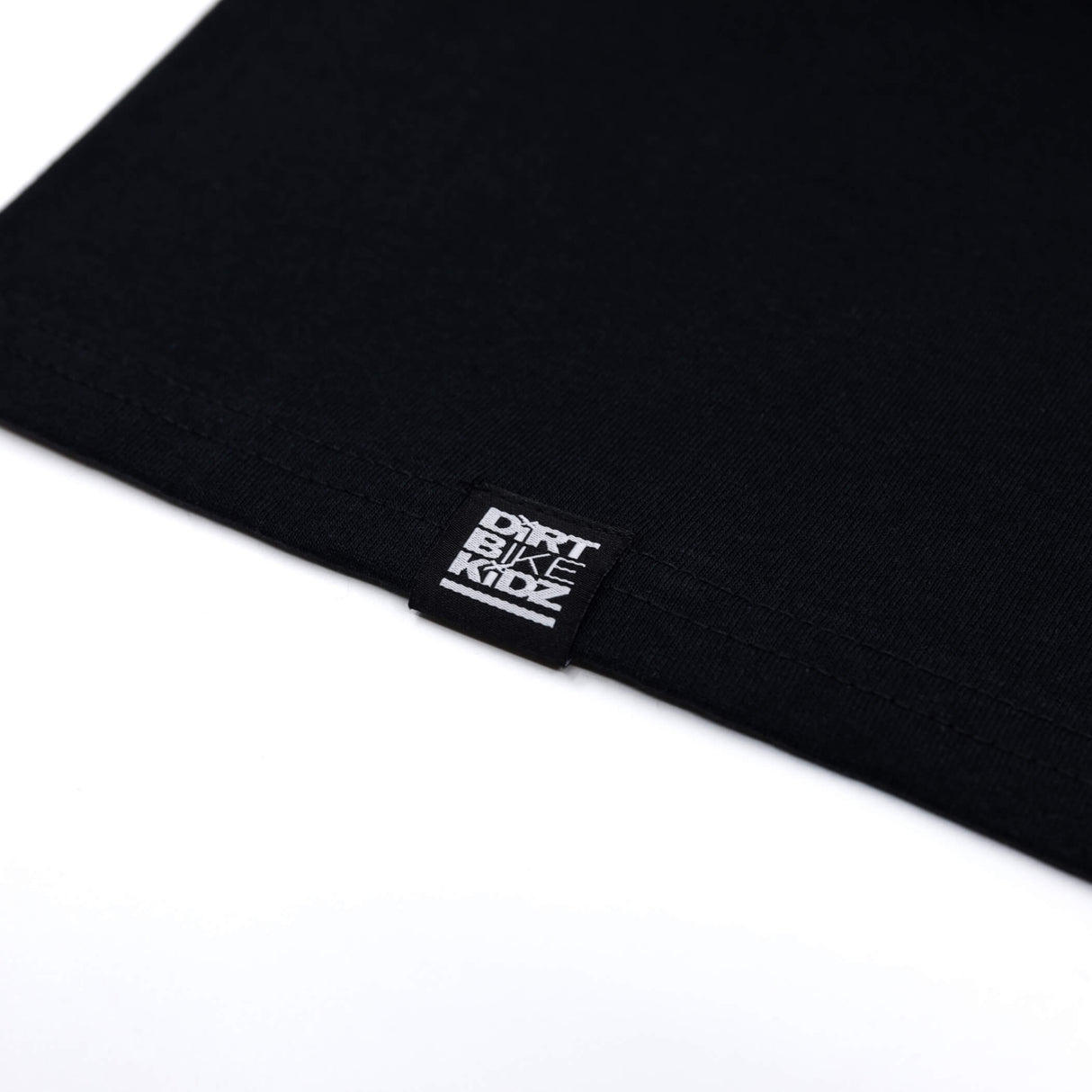 Black tank top hem with white brand label tag