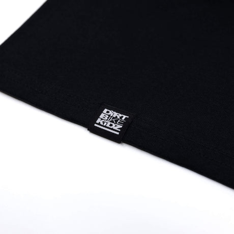 Black tank top hem with white brand label tag