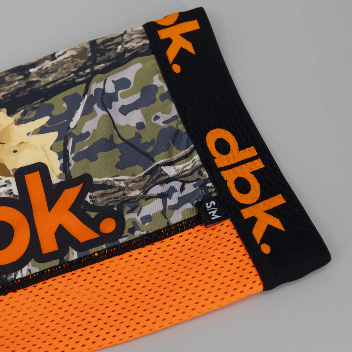 Moto socks in black with orange logo accents and camo legs; includes S/M tag.