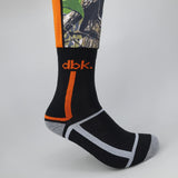 Black crew sock with orange stripe and white band design; camo upper section.