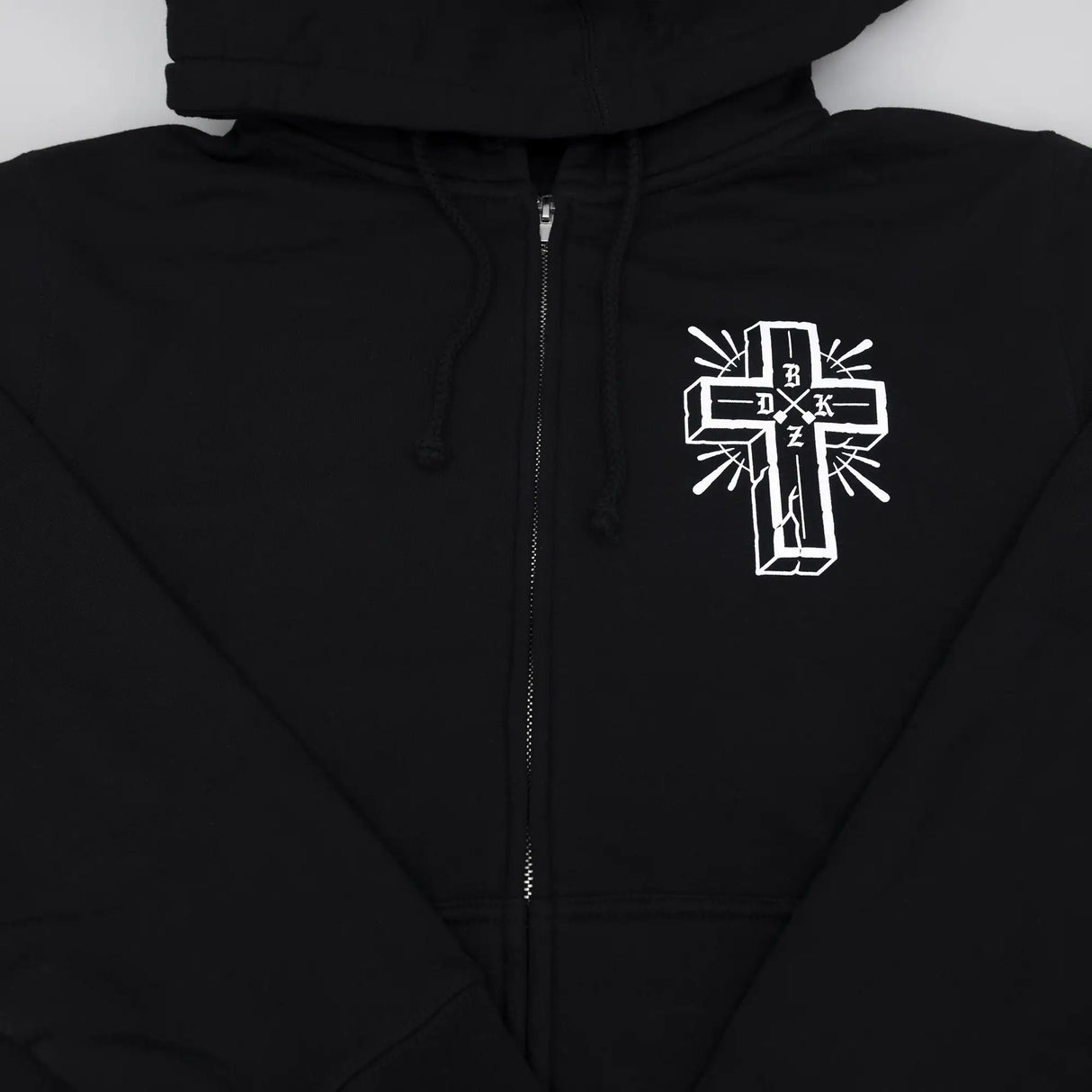 Black zip hoodie front with hood drawstrings, zipper, and small white cross emblem.