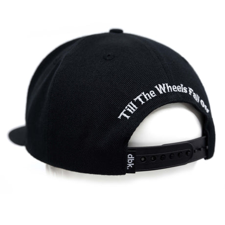 Black snapback cap back view with white slogan embroidery and adjustable strap.