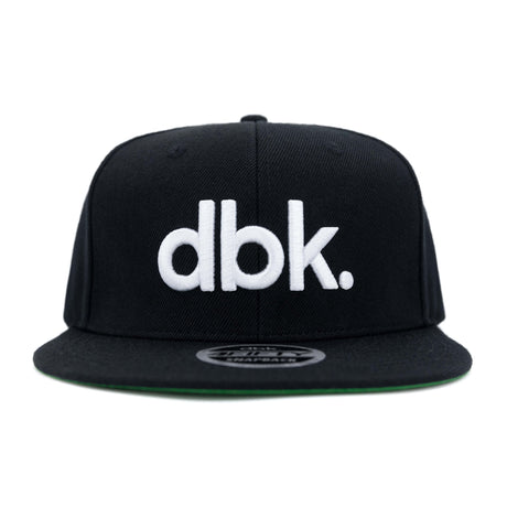 Black snapback cap with large white dbk logo on front panel