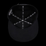 Black snapback hat interior showing stitched lining with dbk 4FIFTY repeat labels