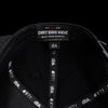 Black snapback hat interior label with Dirt Bike Kidz branding tape.