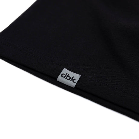 Black tank top hem with dbk label tag on side.