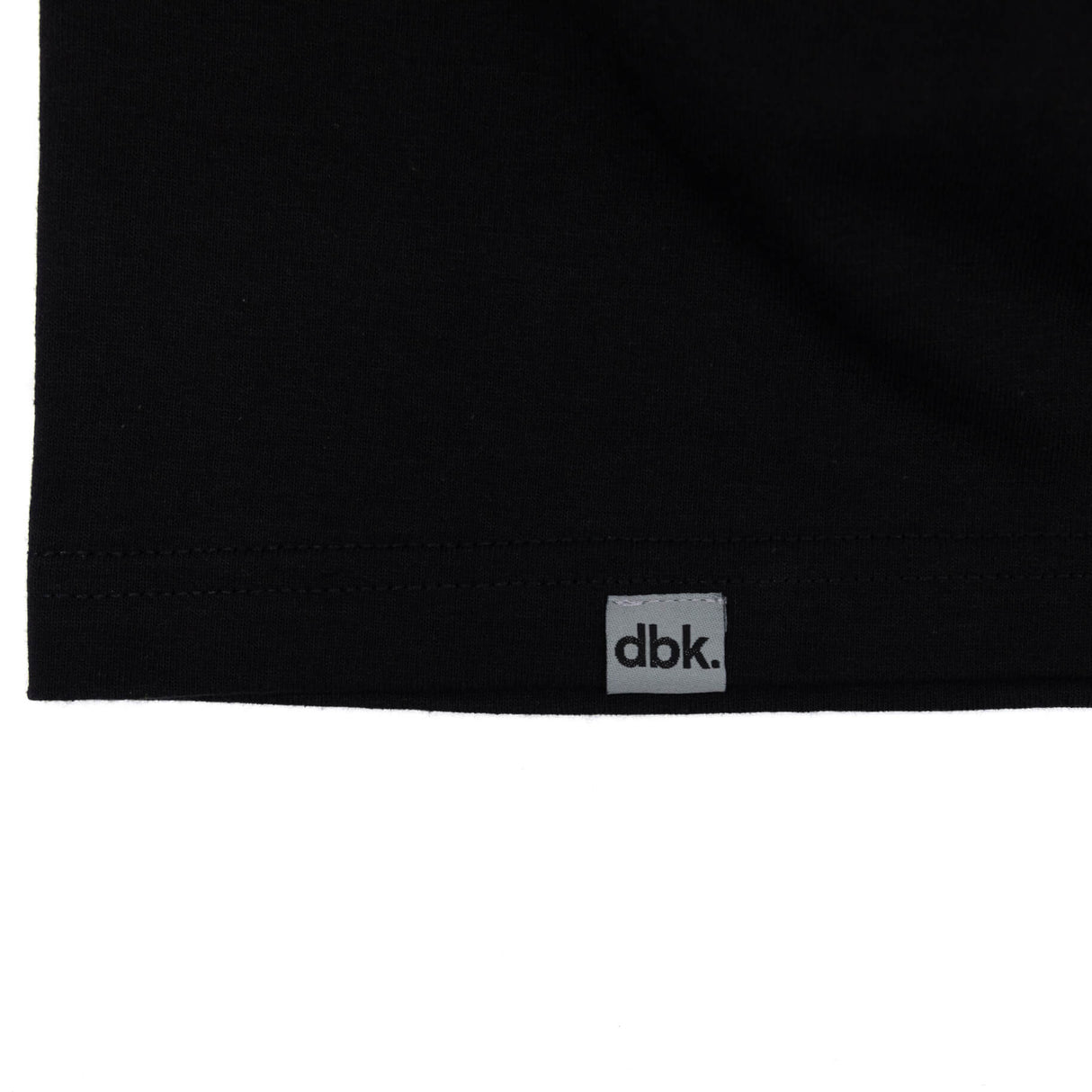 Black tank top hem with dbk label tag centered.