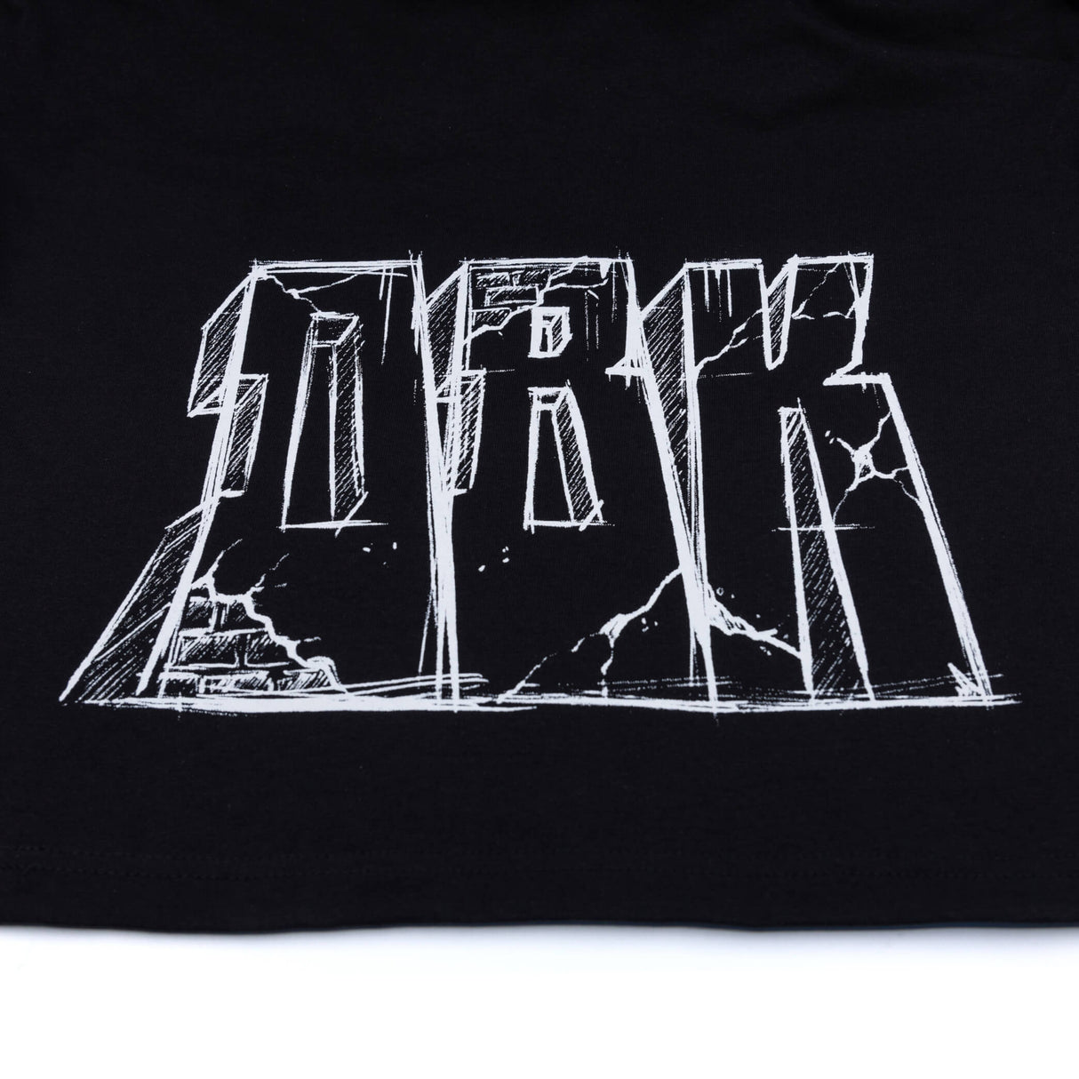 Black T-shirt close-up of large white graphic lettering across chest