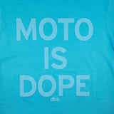 Women’s graphic T-shirt in teal with centered white “Moto is Dope” text print and dbk. mark.