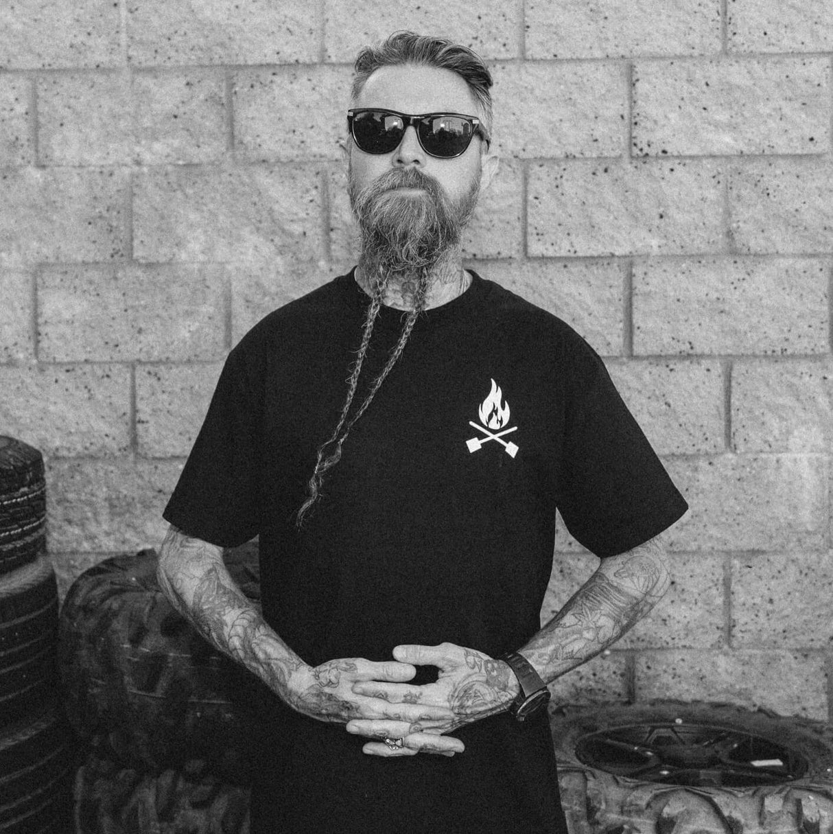 Black T-shirt with small flame logo at upper chest