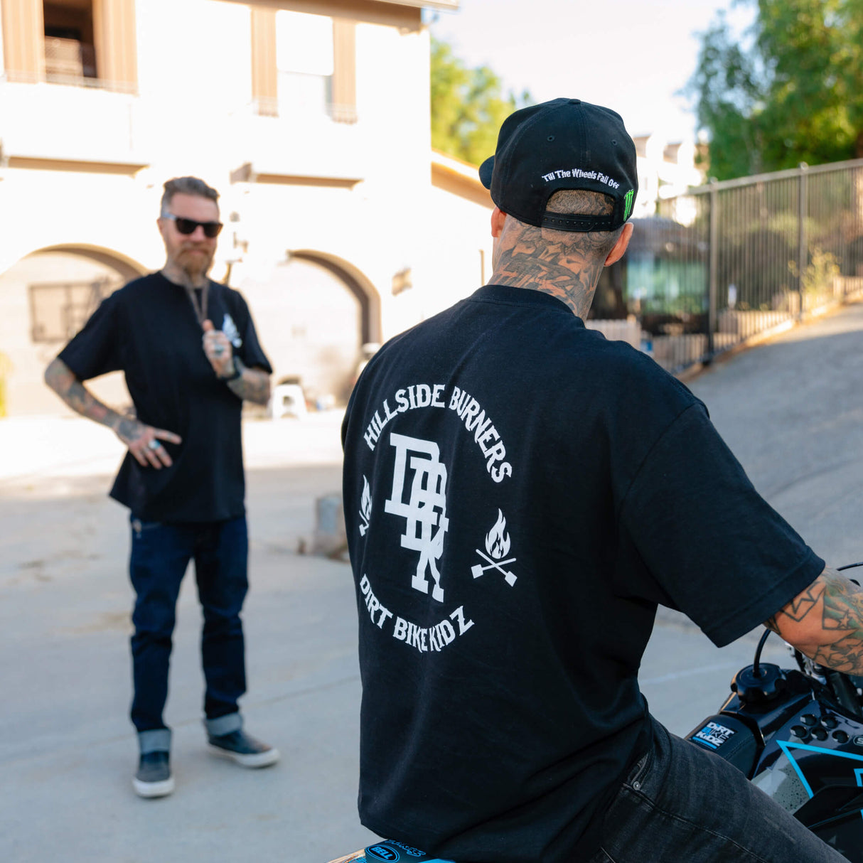 Black T-shirt back graphic with flame icons and bold center logo