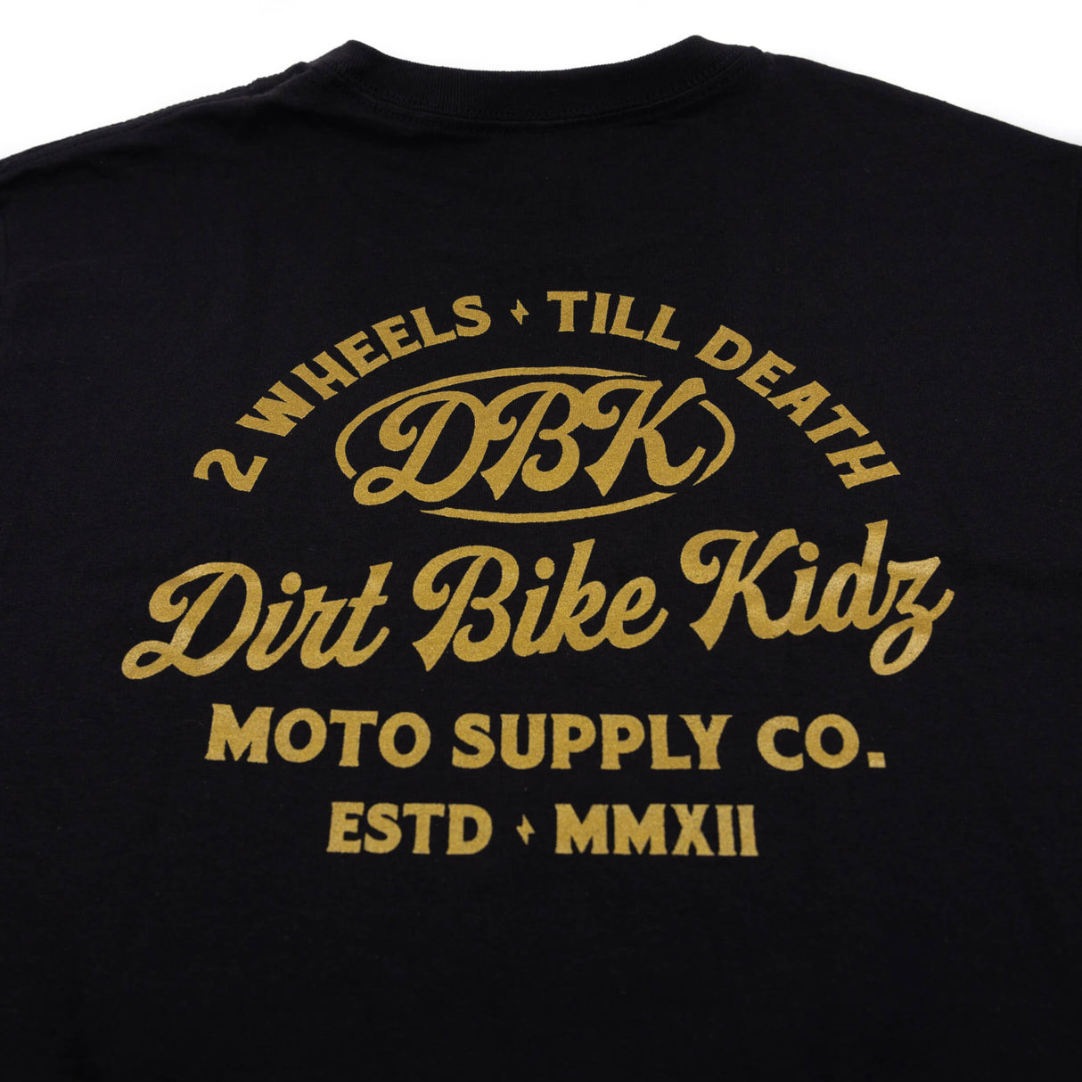 Black graphic T-shirt close-up of large gold DBK Dirt Bike Kidz back print