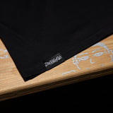 Black tank top hem with “DirtBike Kidz” logo on the bottom edge