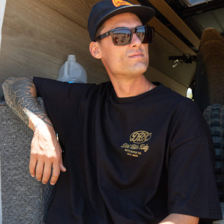 Gold Nugget Tee: black kids T-shirt with small gold chest “DBK” logo