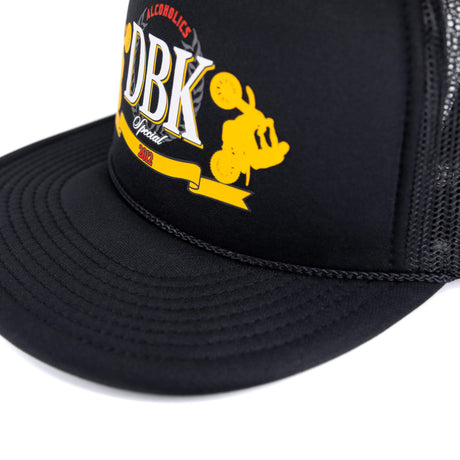 Black trucker hat brim and front panel with embroidered DBK graphic in yellow