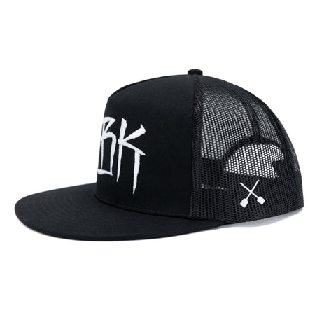 Black trucker cap with white DBK lettering, mesh side panels, and small cross emblem