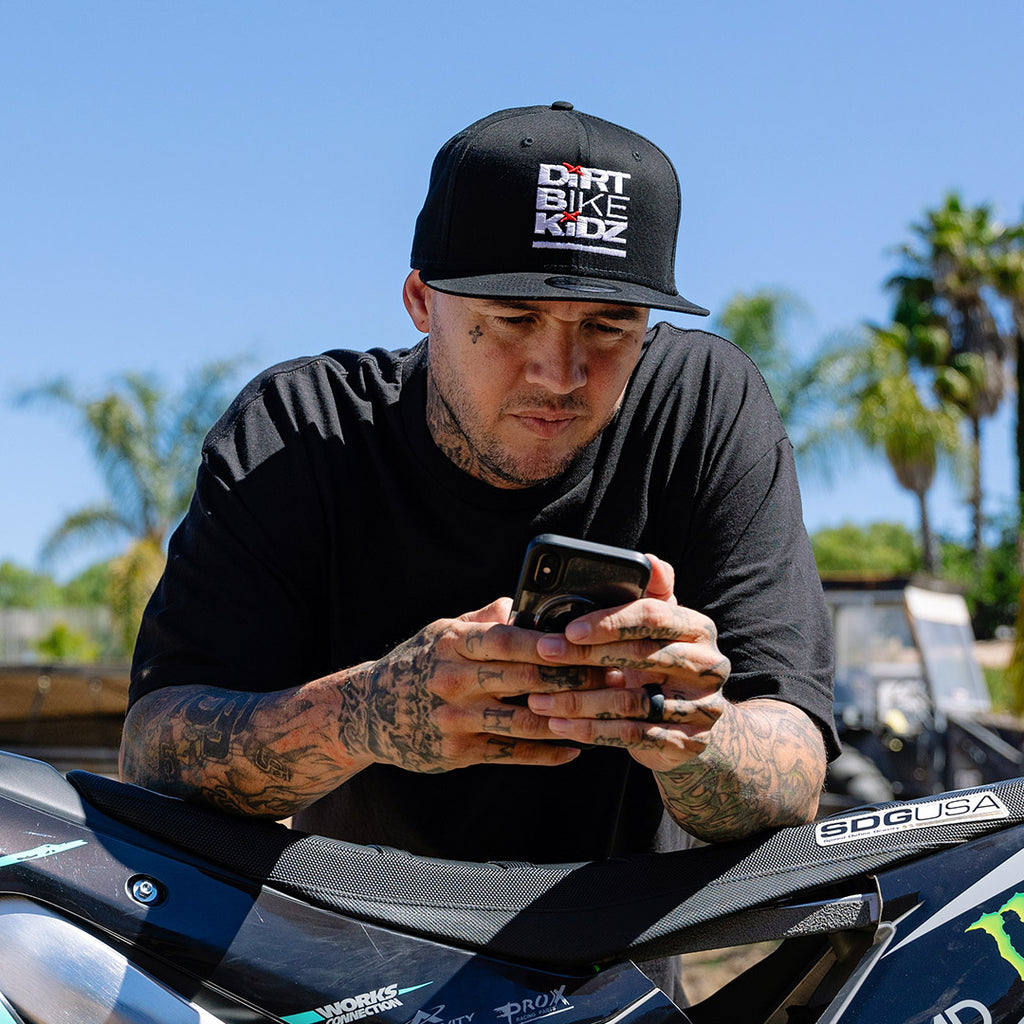 Black snapback hat with Dirt Bike Kidz logo on the front.