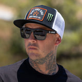 Black and white trucker hat with front orange logo patch and 2FIFTY DBK side.
