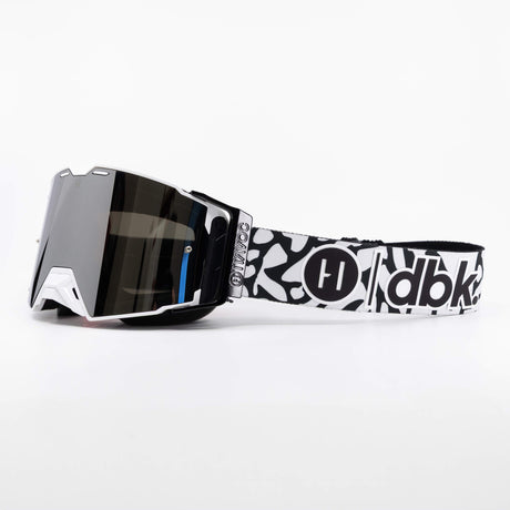 Helios goggle side view with dark mirrored lens and black-and-white patterned strap