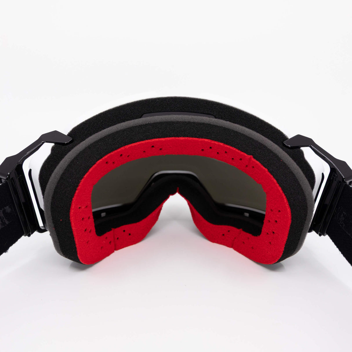Helios goggles with black frame and red foam seal, dark curved lens