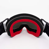 Helios goggles with black frame and red foam seal, dark curved lens