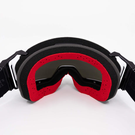 Helios goggle with black frame and red foam, dark tinted lens