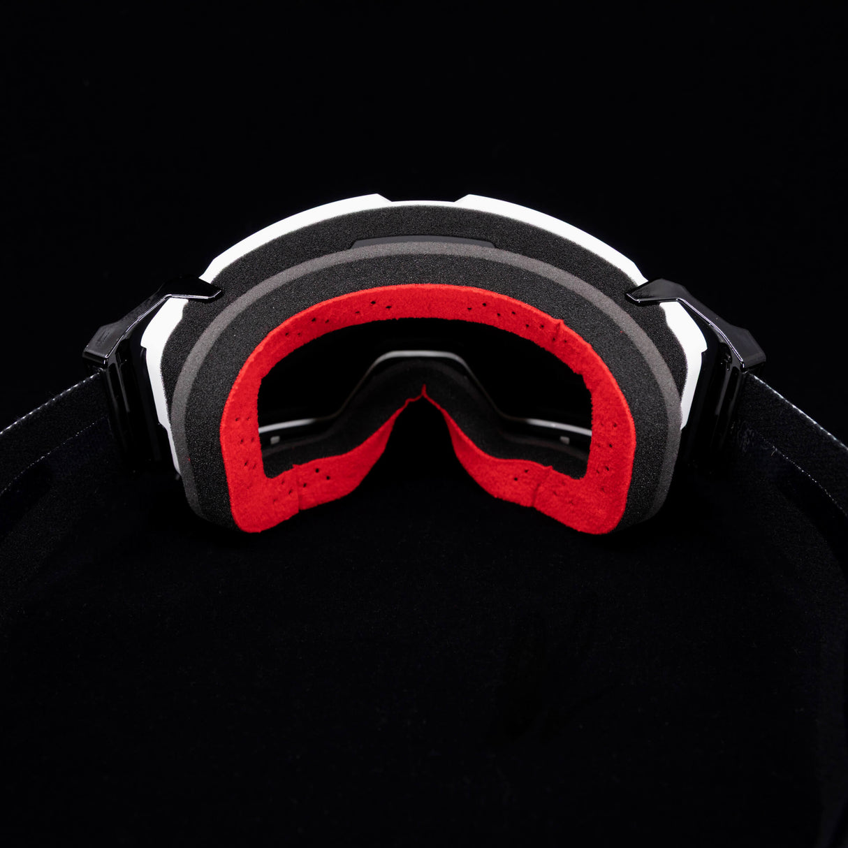 Helios goggle front view with black frame and red inner foam