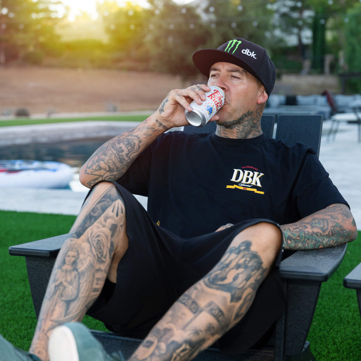 Black graphic T-shirt worn outdoors with DBK logo printed on the chest