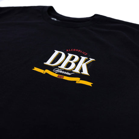 Black T-shirt back detail with vertical yellow lettering and small DBK emblem near shoulder
