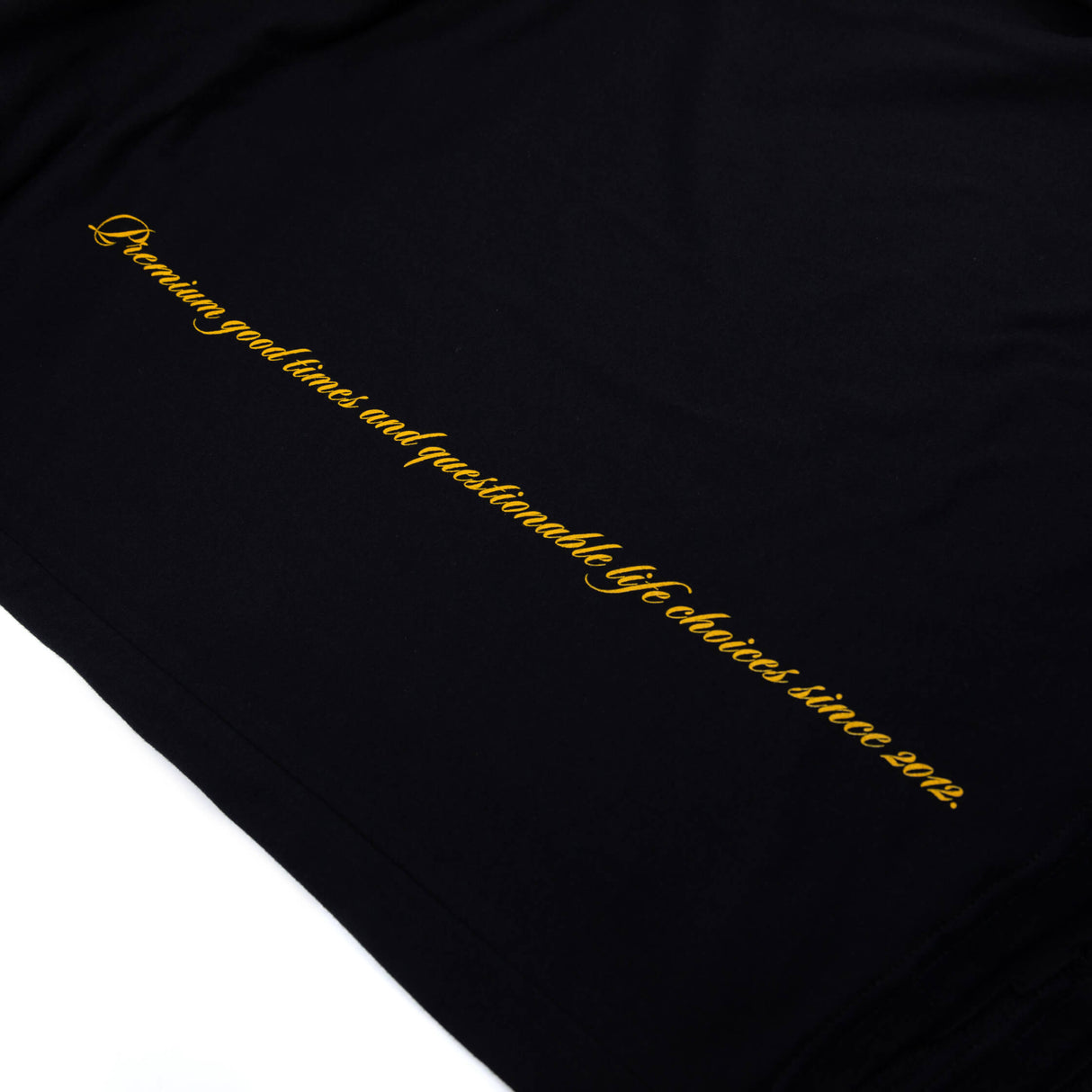 Black T-shirt fabric with angled vertical yellow script print