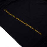 Black T-shirt fabric with angled vertical yellow script print