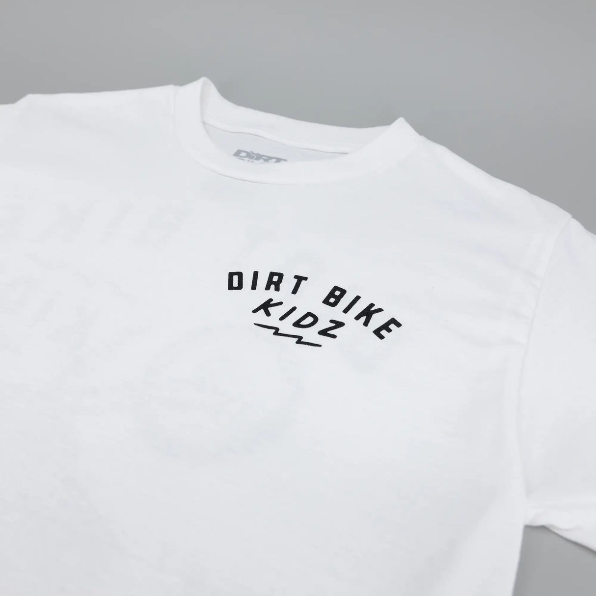White kids T-shirt with centered Dirt Bike Kidz logo on chest.