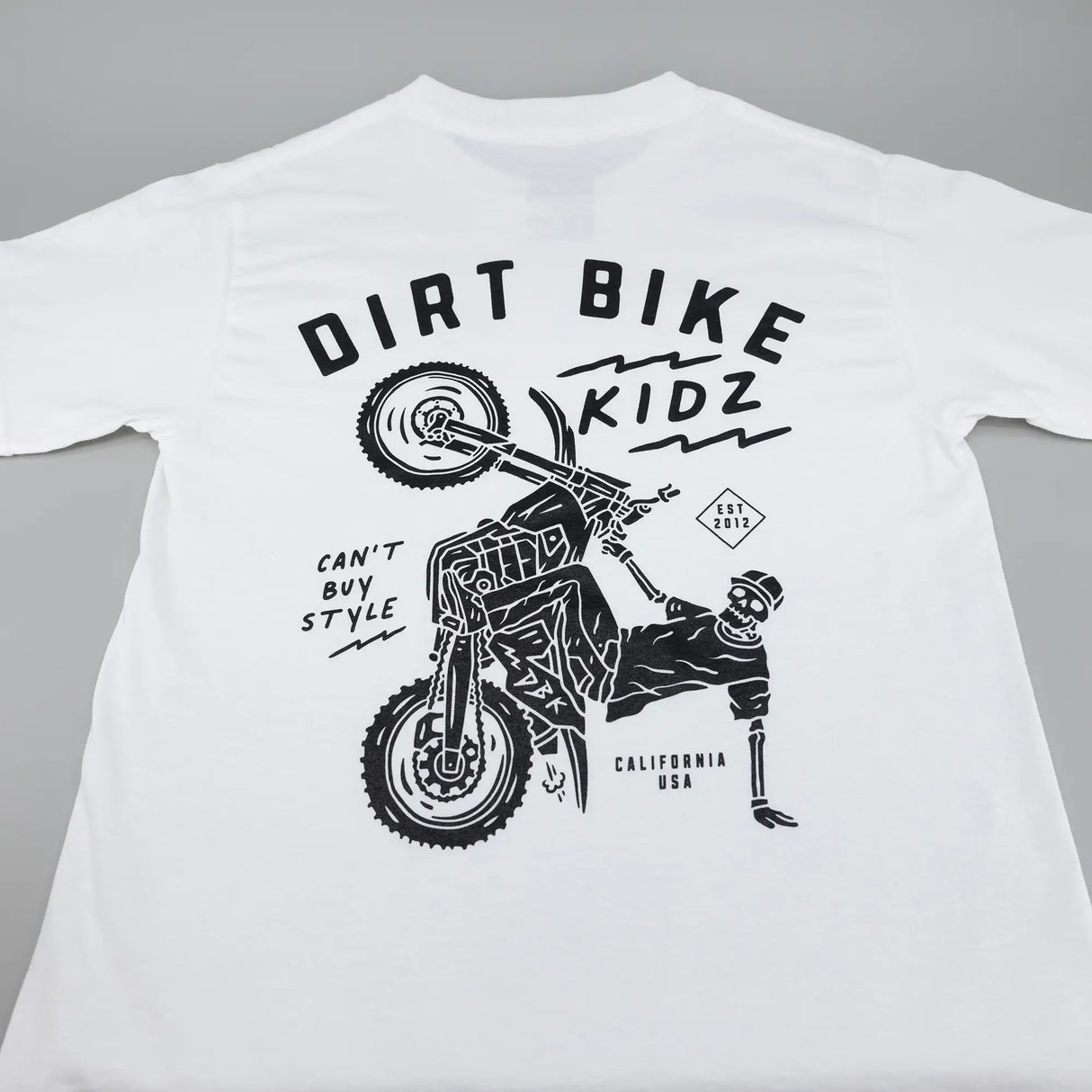 White kids T-shirt with large Dirt Bike Kidz rider graphic on back.