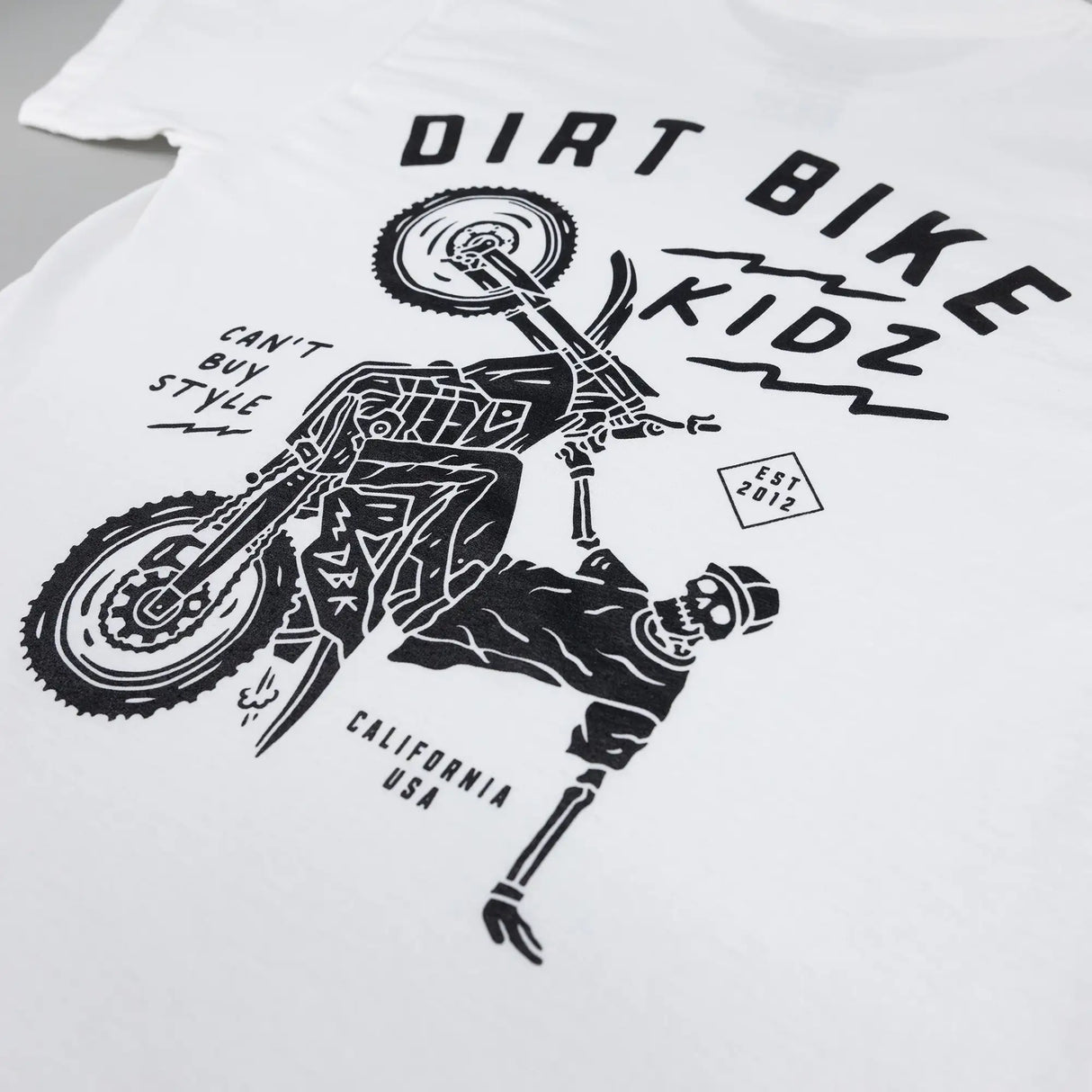 White kids T-shirt with large Dirt Bike Kidz rider print across back.
