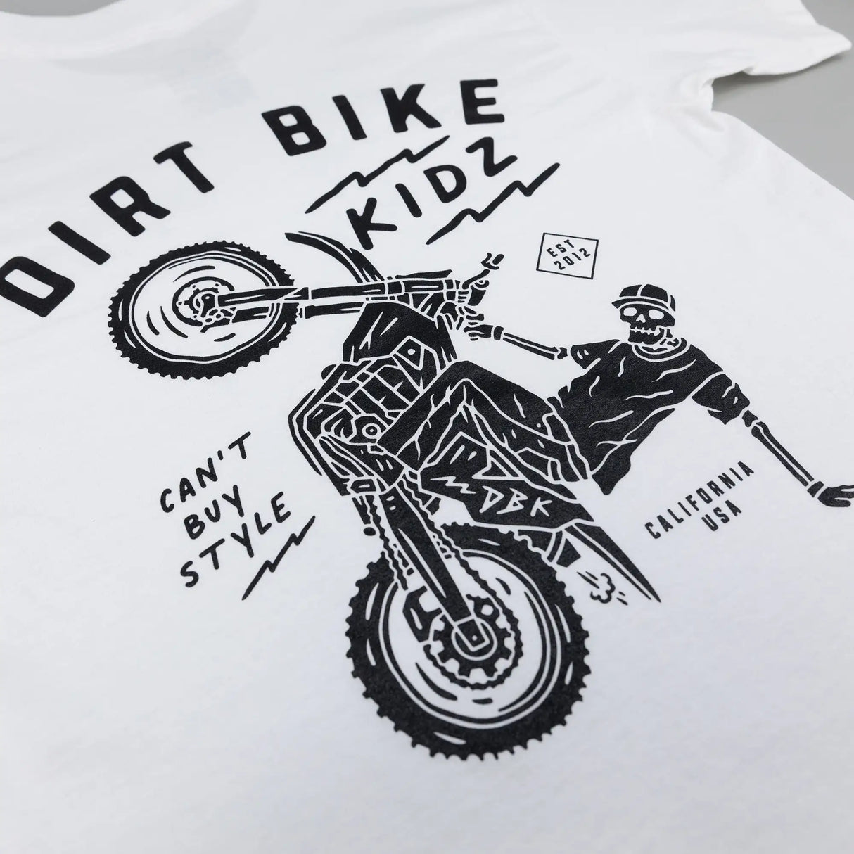 White kids T-shirt with Dirt Bike Kidz motocross rider graphic on back.
