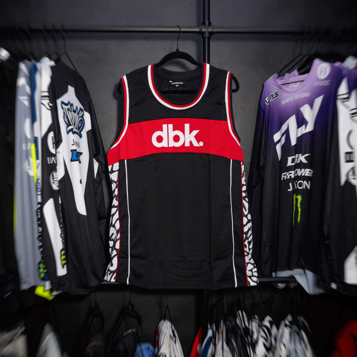 Black jersey tank with red chest band and white-red neckline and armhole trim.
