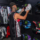 Black jersey tank on model, showing side panel graphic and white-red trim details.