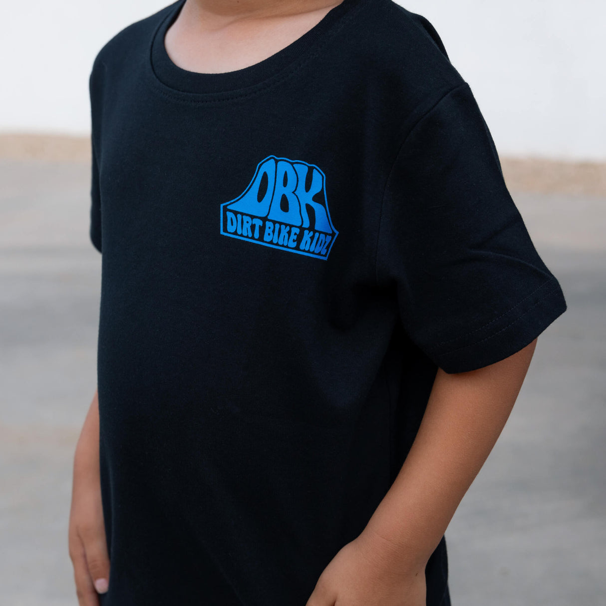 Toddler black T-shirt with blue ORK Dirt Bike Kidz chest logo