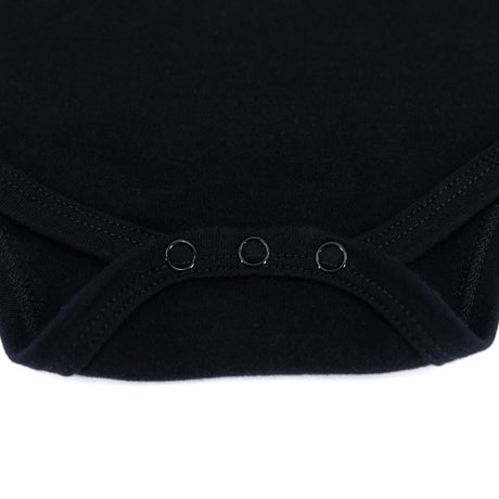 Black baby onesie close-up of leg opening with three snap buttons